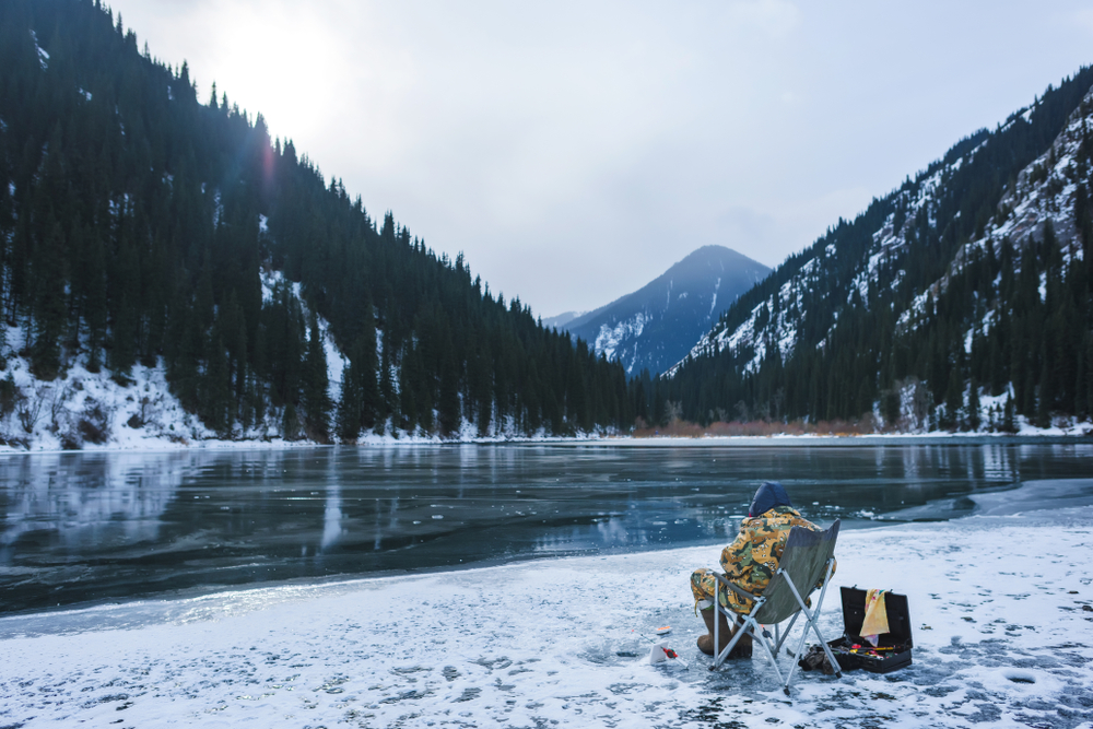 Biggest bass fishing myths - a man fishing in winter.