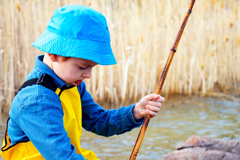 A Little Fisherman Holds a Bamboo Rod