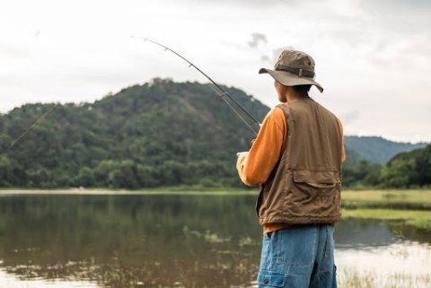 Best Seasons for Bass Fishing: Man Fishing in Late Summer.