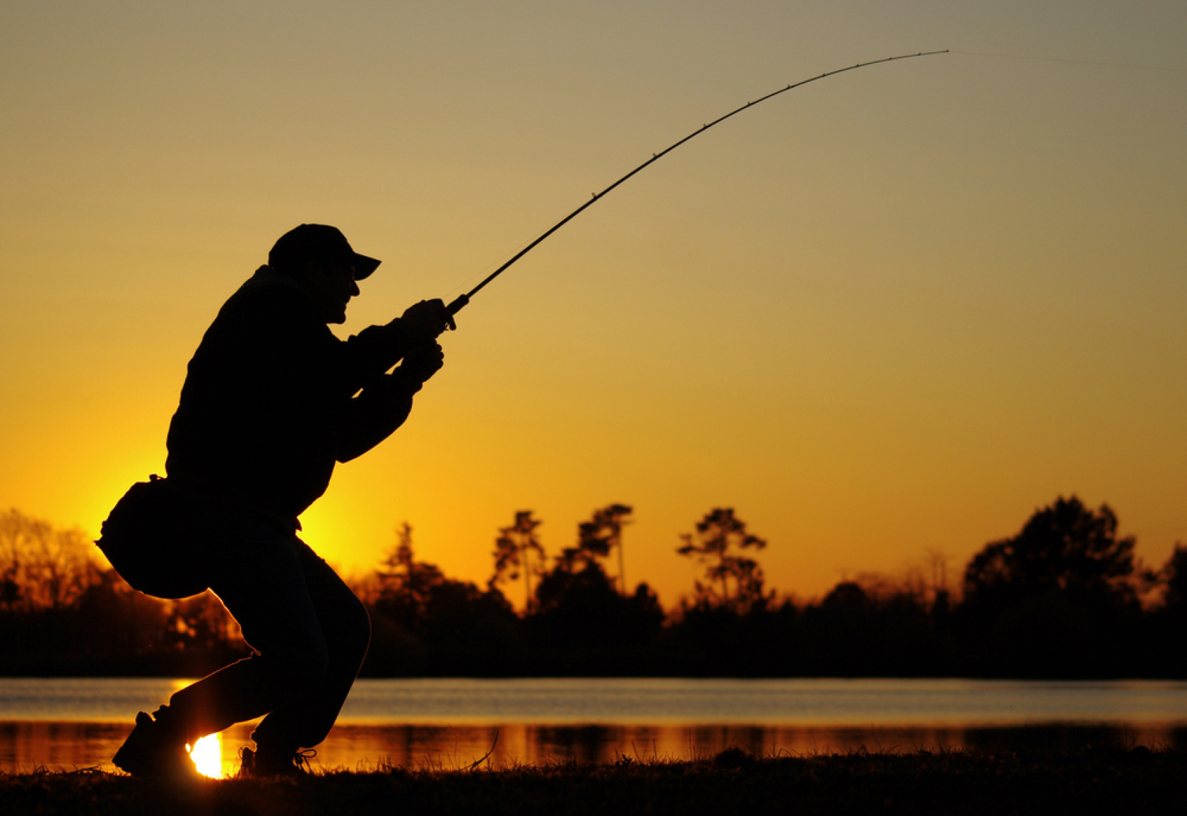 Man fishing in the sunset