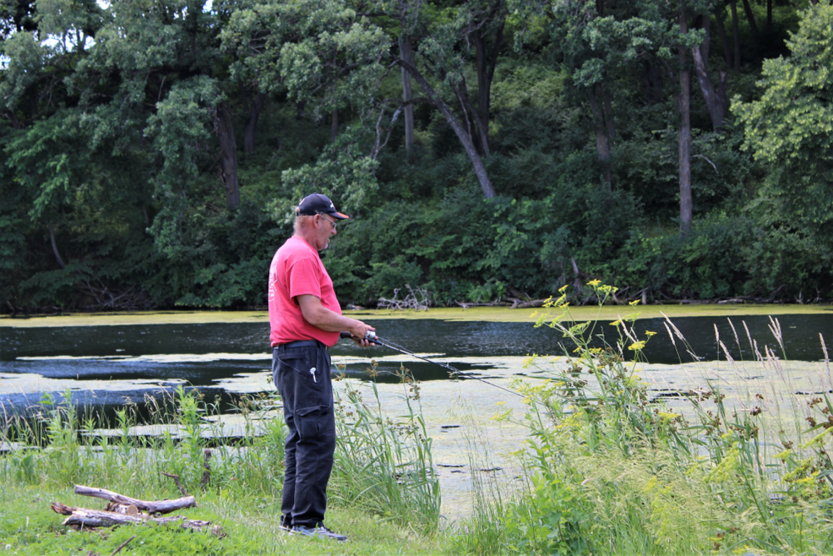 A guy fishing, trying to break one of the bass fishing records in Iowa.