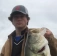 Young male holding large Bass fish